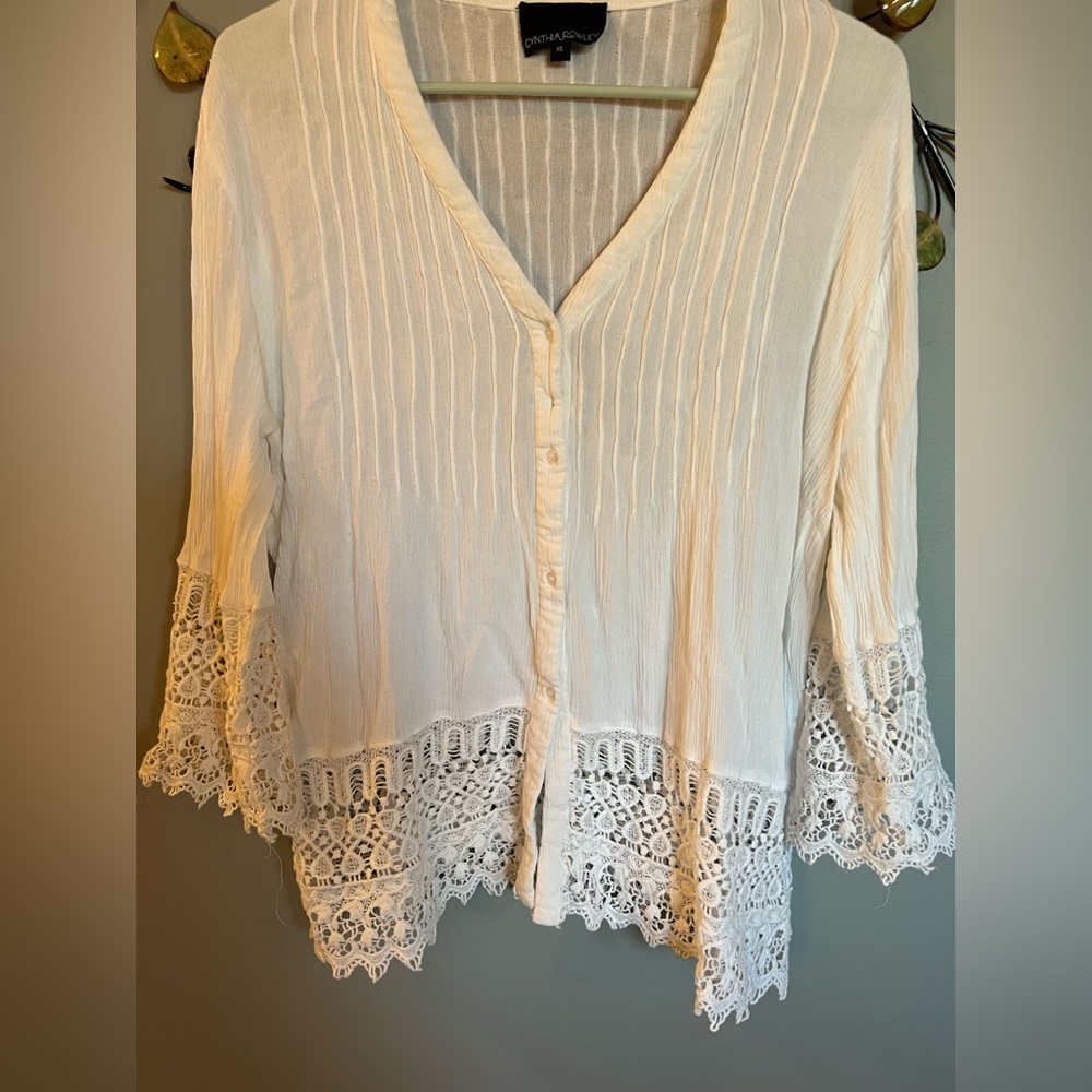 Cute lightweight button down top with embroidery on bottom and lower sleeve
